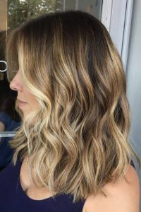 A woman’s hair after professional color correction and root shading, showing rich, even tones and shine